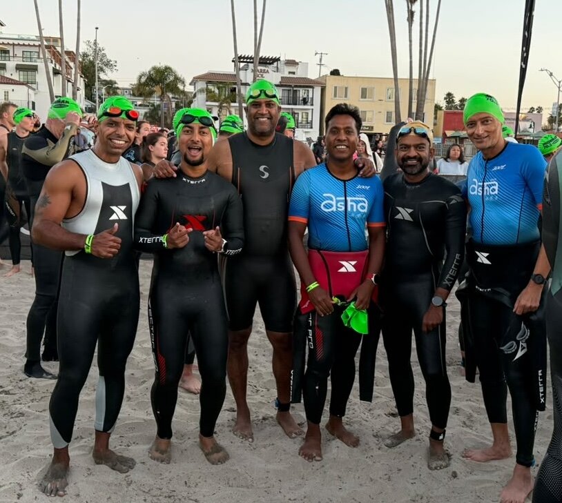 Team Asha swimmers on the beach before the relay swim