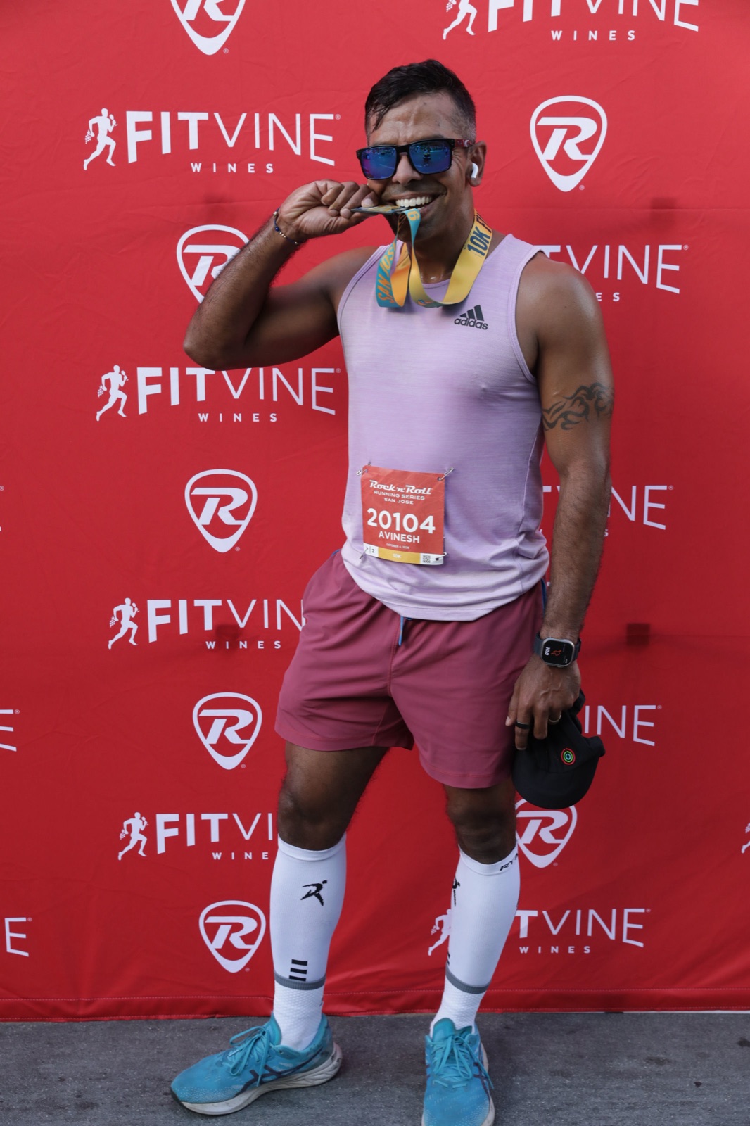 Rock 'n' Roll San Jose 10K 2026 — biting the finisher medal